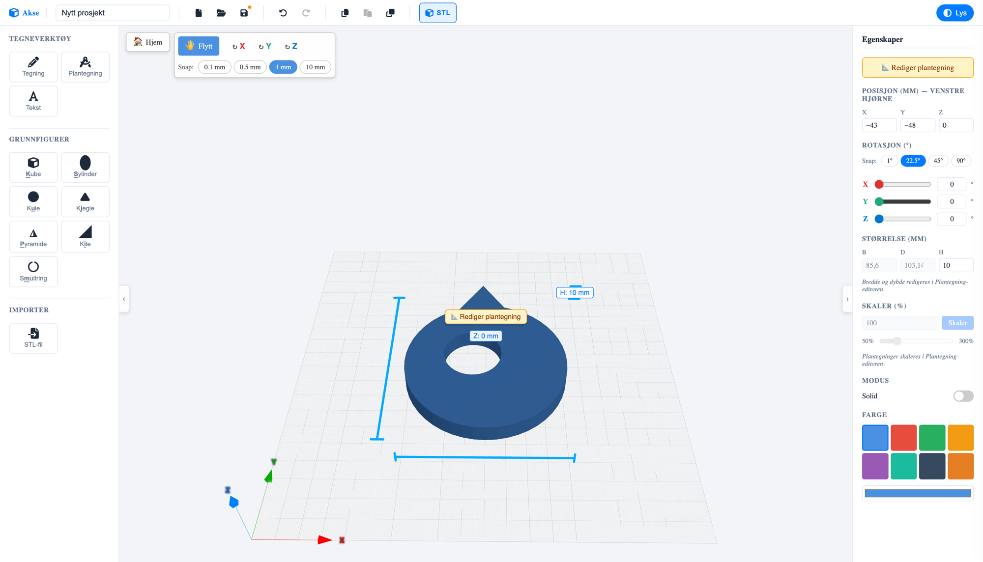 Akse-editoren: en blå smultring-formet 3D-modell med hull, omgitt av figurbibliotek til venstre og egenskapspanel til høyre